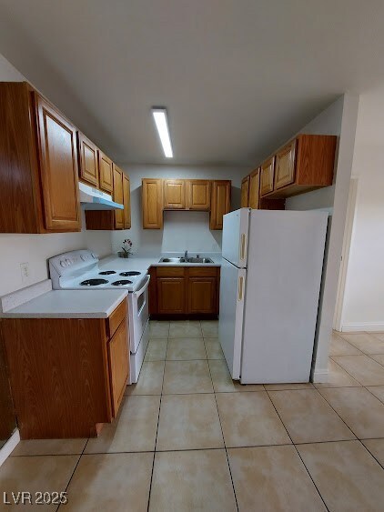 Kitchen with white appliances, under cabinet range