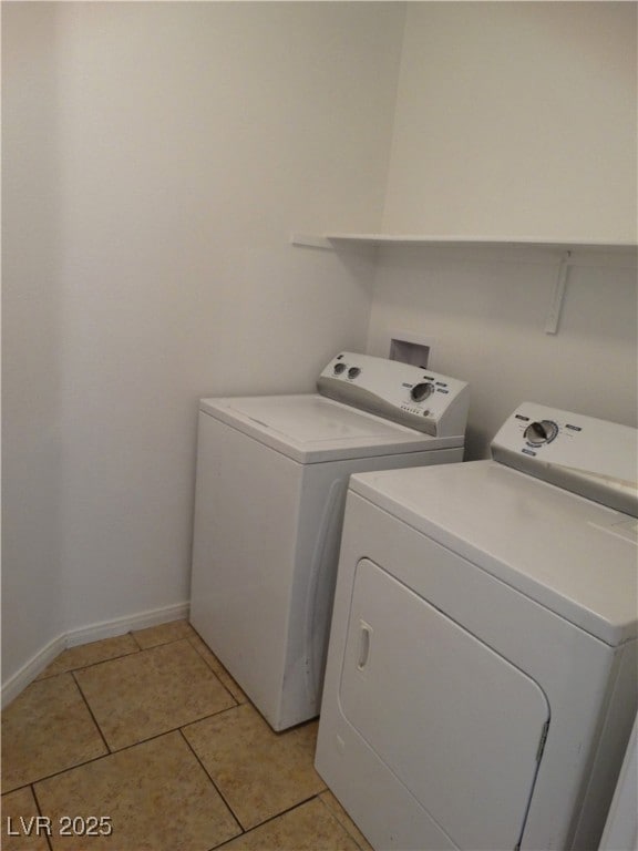 Washroom with light tile patterned flooring, baseb