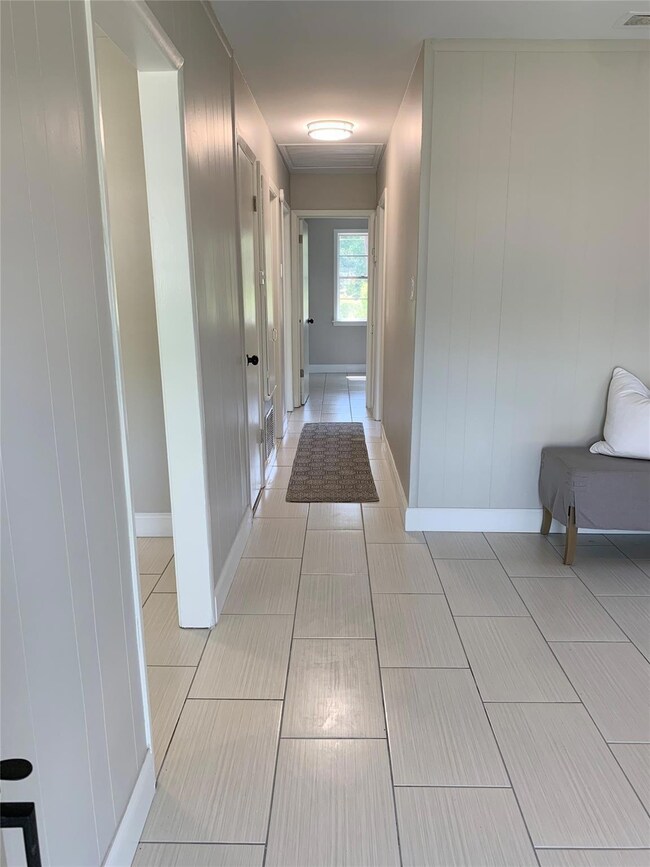 Hallway featuring light tile patterned flooring