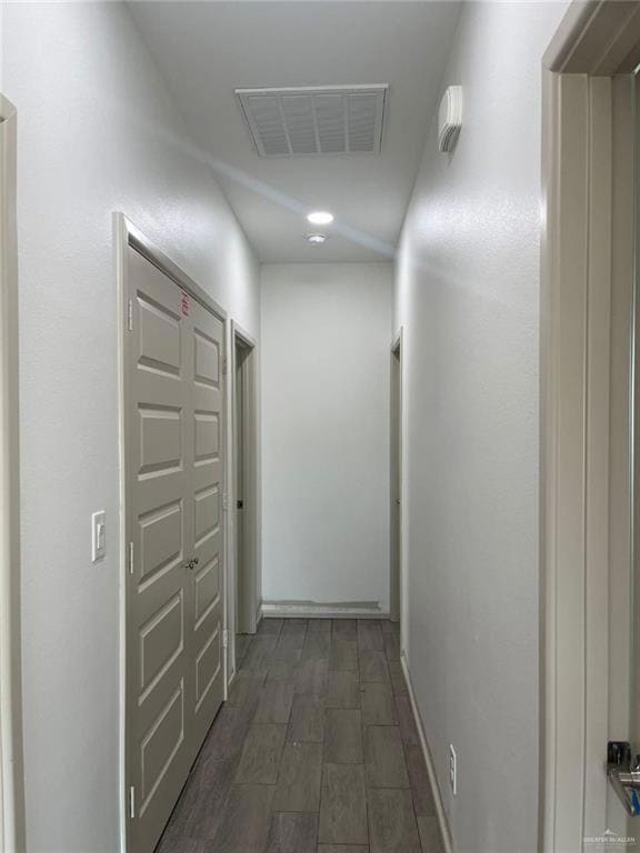 Corridor with baseboards and wood finish floors
