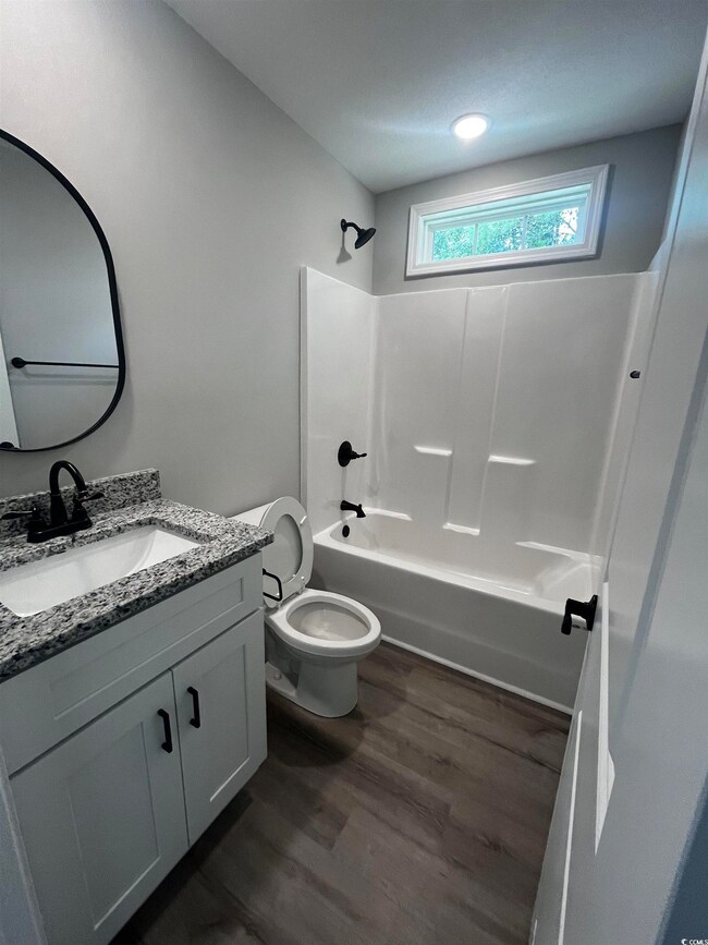 Full bathroom with vanity, shower / bath combinati