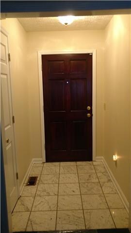 Foyer leading into the Lovely Living Room/Family Room with Trey Ceiling.  