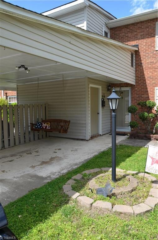 Carport provides shelter to front door.  Private storage unit to the left.