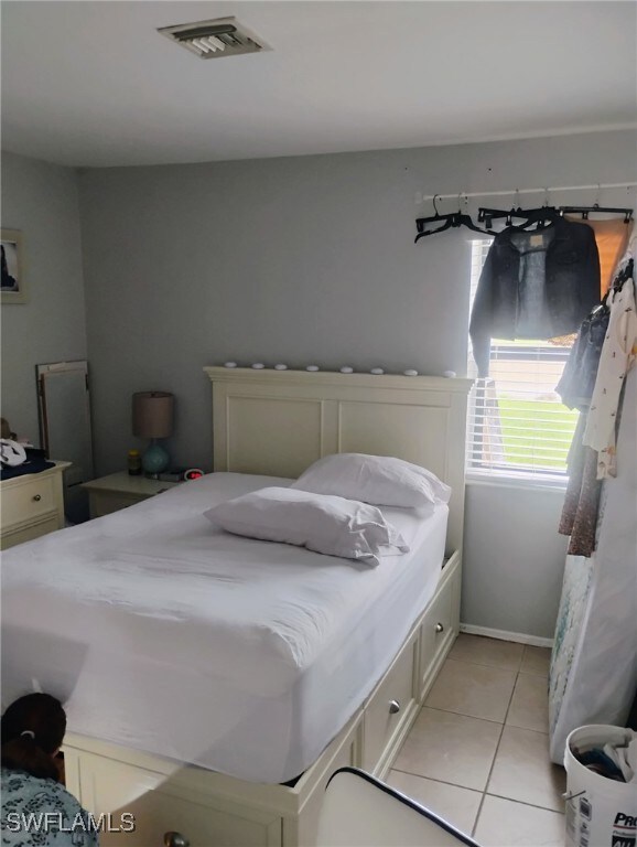 Bedroom with light tile patterned floors