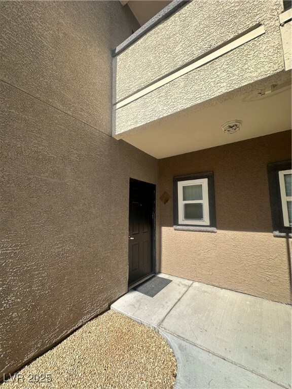 Property entrance with stucco siding