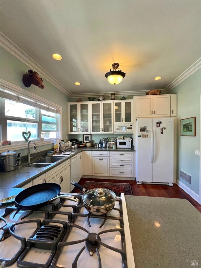 Unit 102 features a spacious kitchen with generous cabinetry and ample counter space.