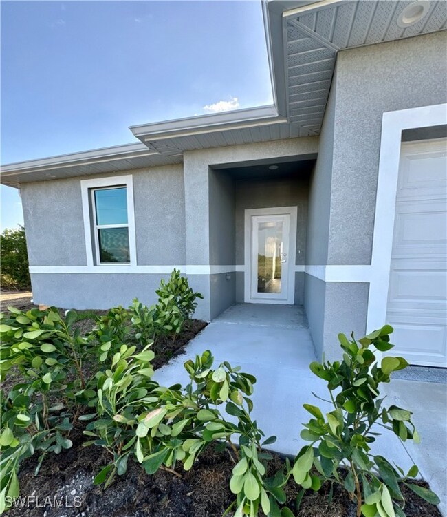 Entrance to property with stucco siding