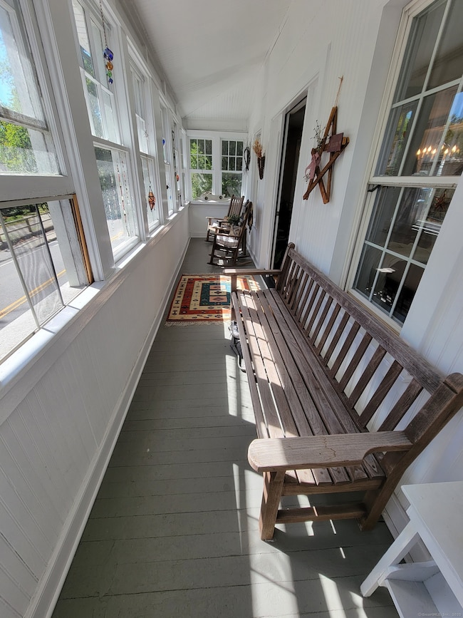 The light -flooded 3 season porch for unit 1 as used currently.