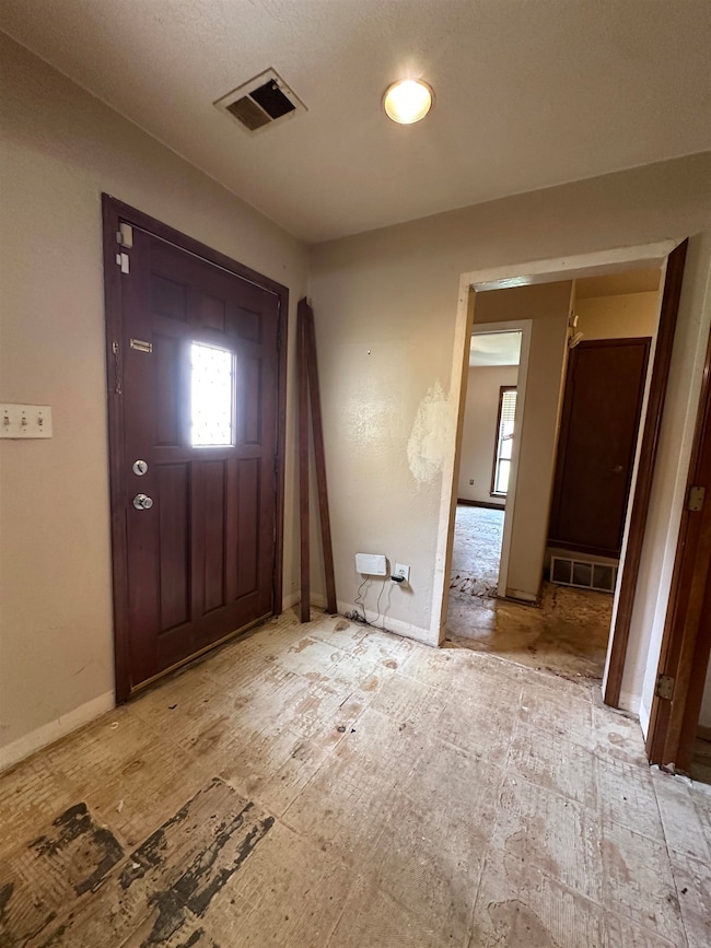 Entryway featuring plenty of natural light and baseboards