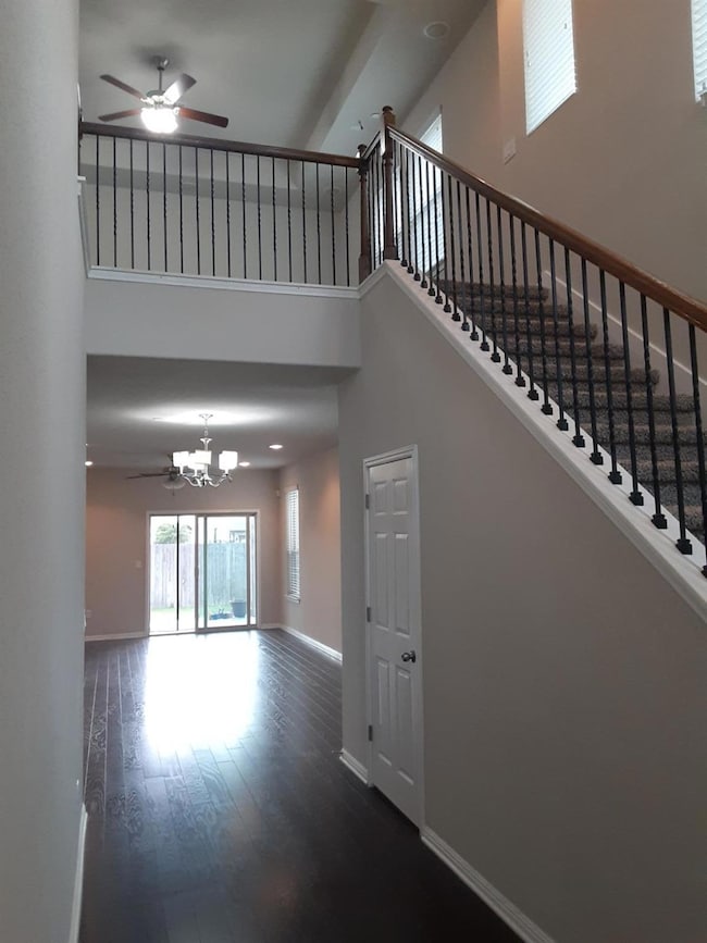 Unfurnished living room with a ceiling fan, a tow