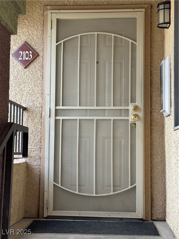 View of exterior entry with stucco siding