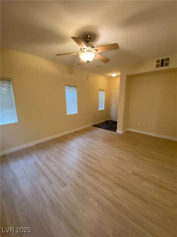Unfurnished room with light wood-style flooring and ceiling fan