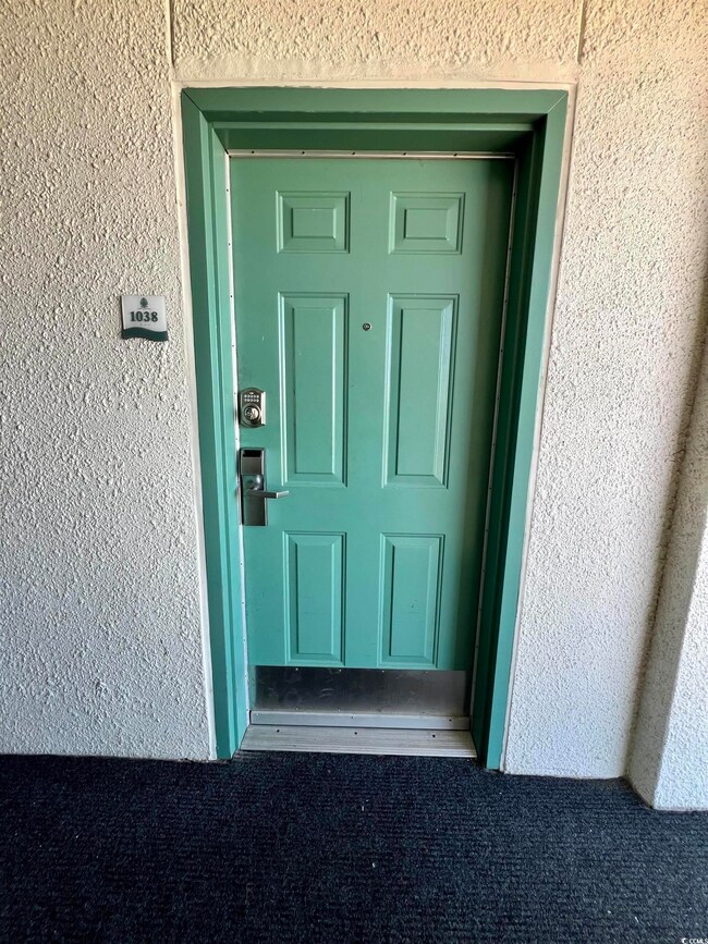 Entrance to property featuring stucco siding