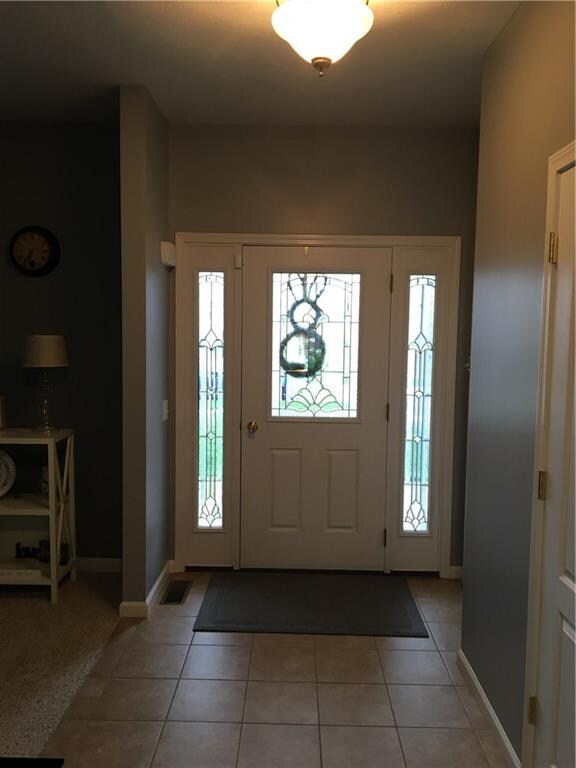 Foyer and front entryway. Front living room on lef