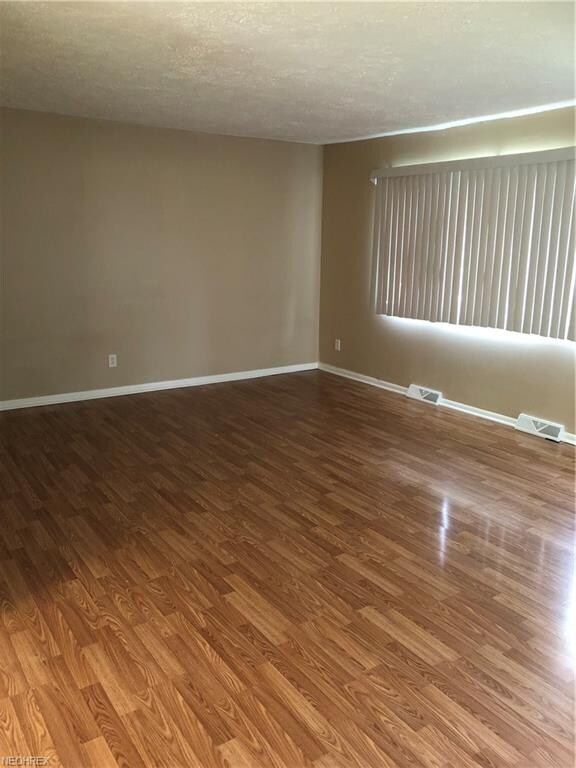 Large living room with laminate flooring.