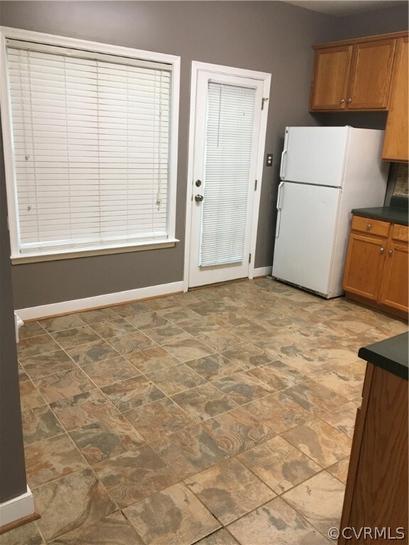 Kitchen with furnished appliances and ceramic tile floor.