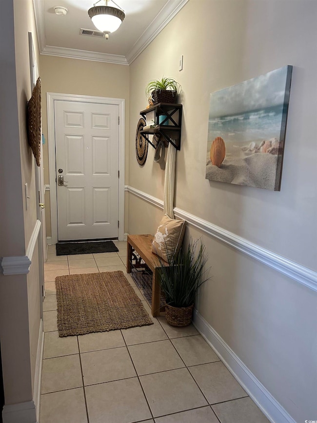 Doorway to outside with baseboards, visible vents,