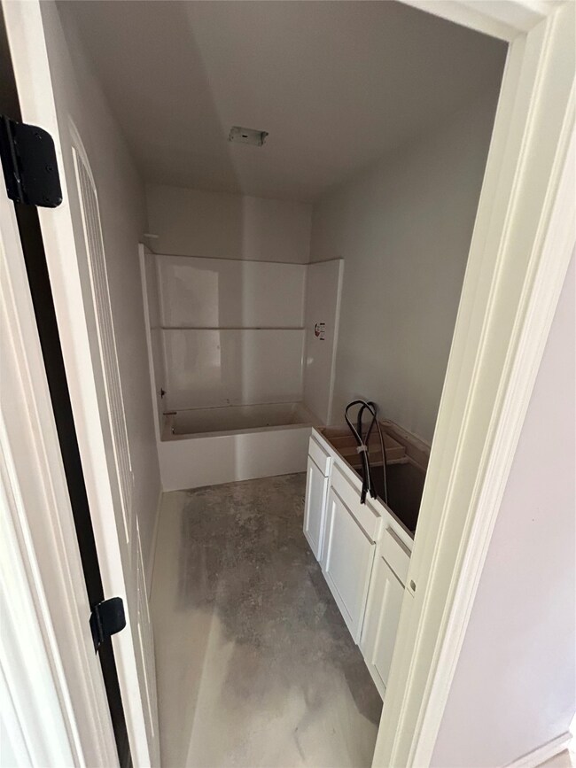 Full bathroom featuring vanity, shower / bath combination, and concrete floors