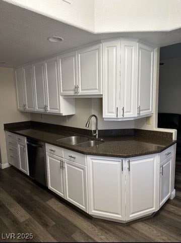 Kitchen with a sink, dishwasher, white cabinetry,