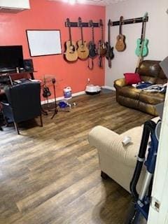 Recreation room with wood finished floors and baseboards
