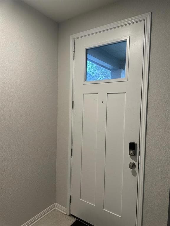 Doorway featuring baseboards