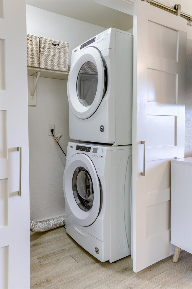 Clothes washing area featuring stacked washing ma