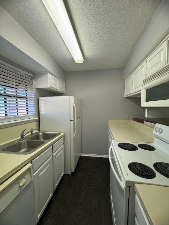 Kitchen featuring light countertops, white applian
