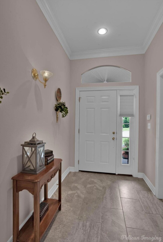 Entrance foyer featuring crown molding and light t
