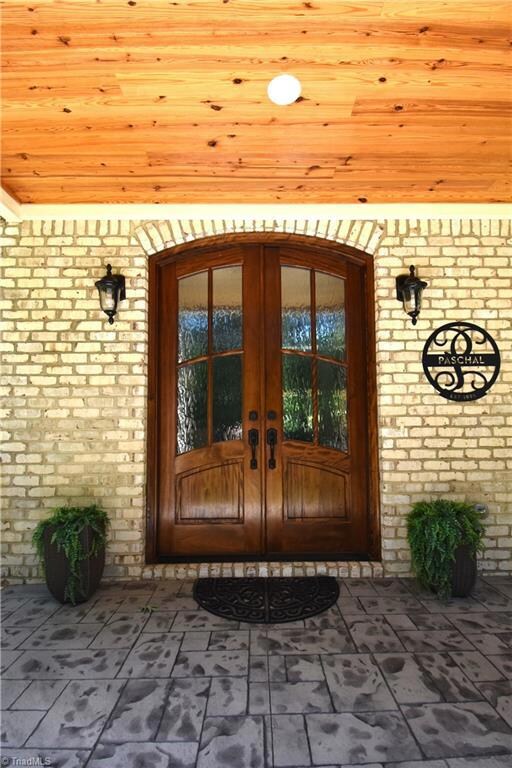 The arched mahogany front door greats you and your guests when you come home. The stamped concrete looks fantastic while being low maintenance.