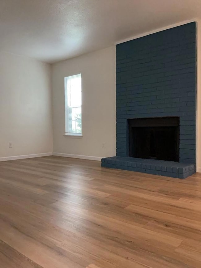 Unfurnished living room with wood finished floors