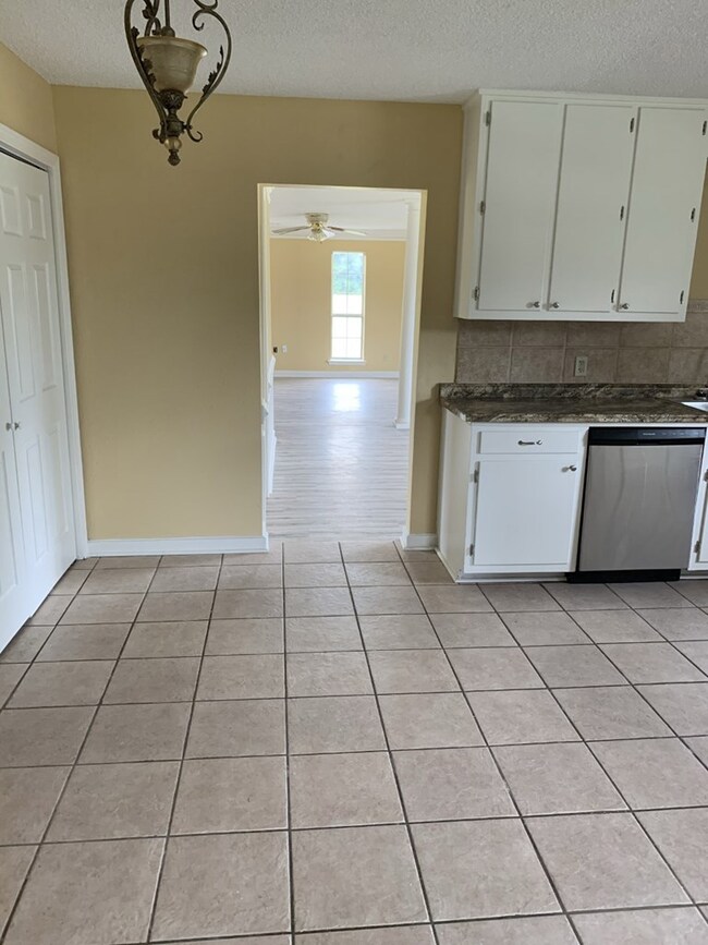 view from kitchen into formal dining and den