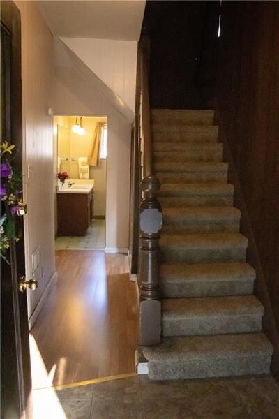 Entrance with view of staircase and bathroom.