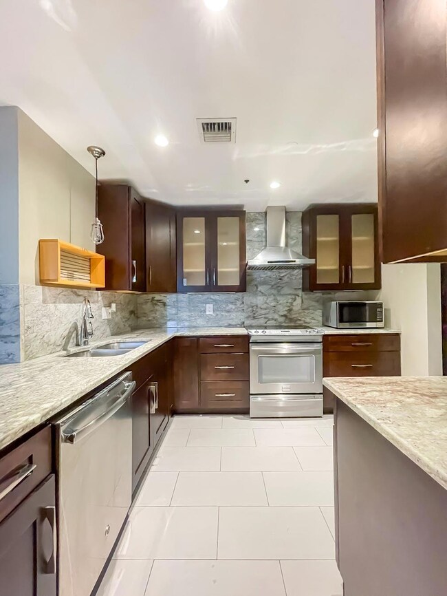 Kitchen with wall chimney exhaust hood, stainless