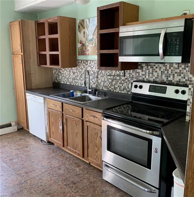 Kitchen with stainless steel appliances, tile floo