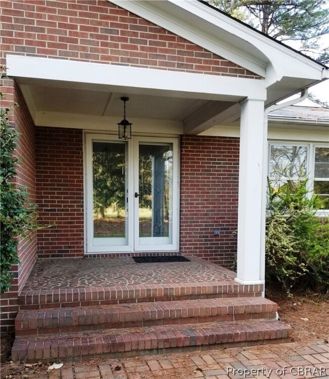 Wide covered front porch welcomes guests.