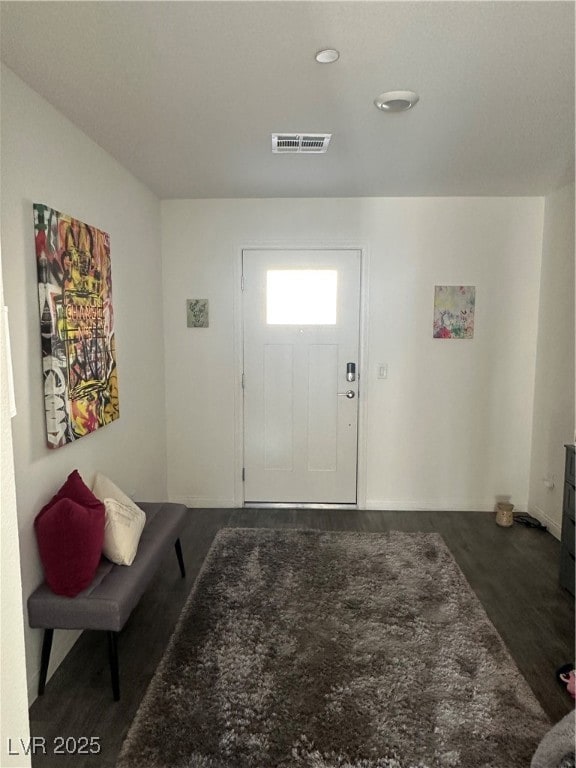 Foyer entrance featuring dark wood-type flooring a