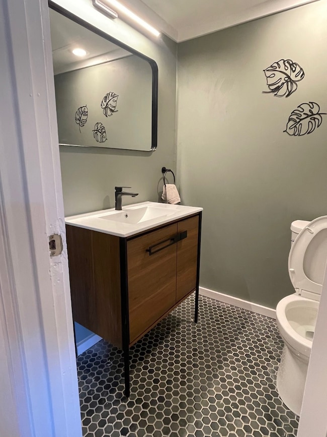 Bathroom featuring vanity and dark tile patterned flooring
