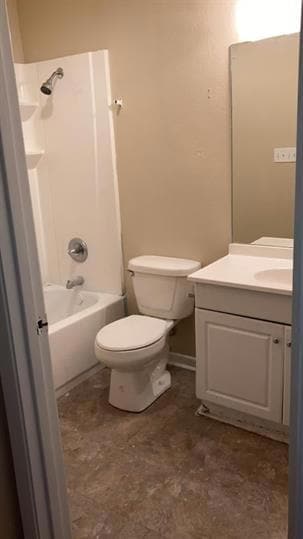 Bathroom featuring shower / bathing tub combination, baseboards, vanity, and toilet