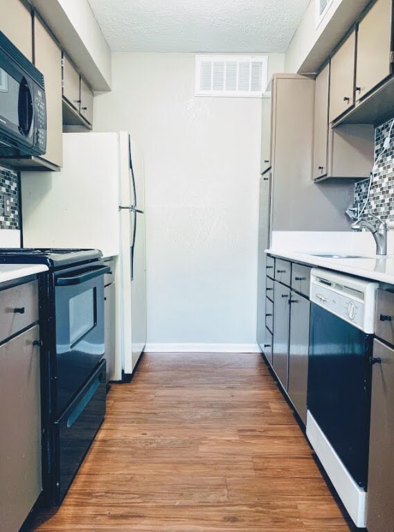 Kitchen featuring light countertops, a sink, light