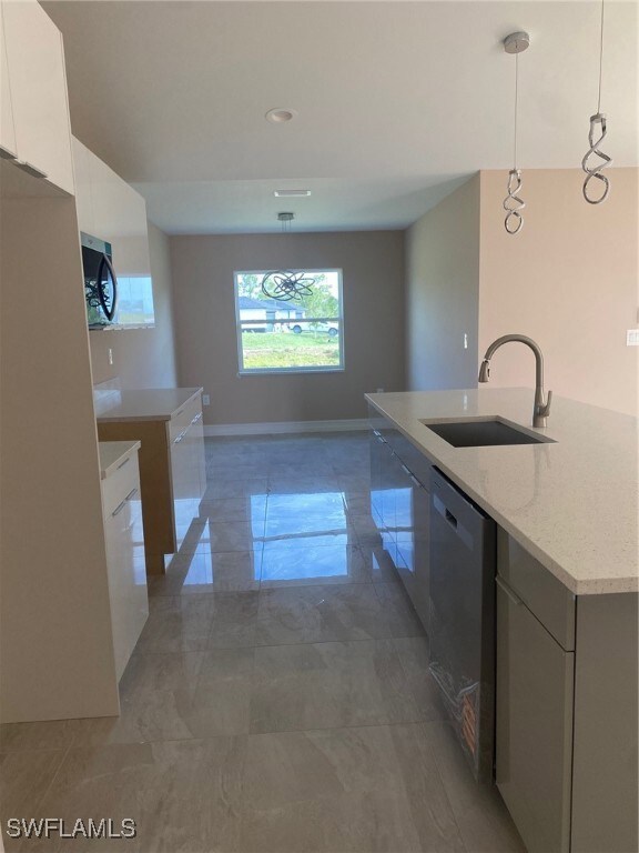 Kitchen featuring white cabinets, marble finish fl