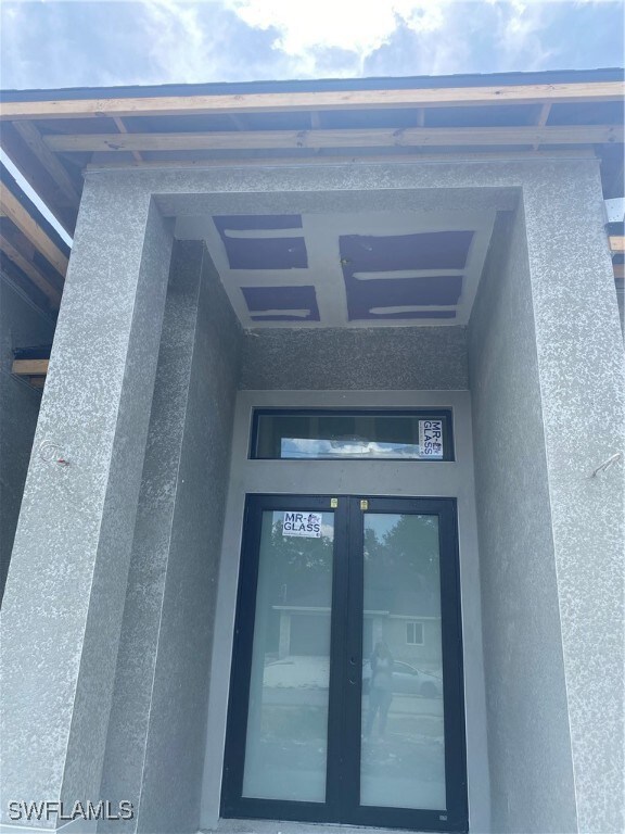 Entrance to property featuring stucco siding