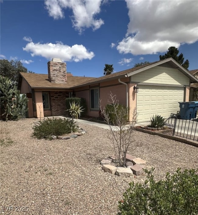 Ranch-style home with concrete driveway, stucco si
