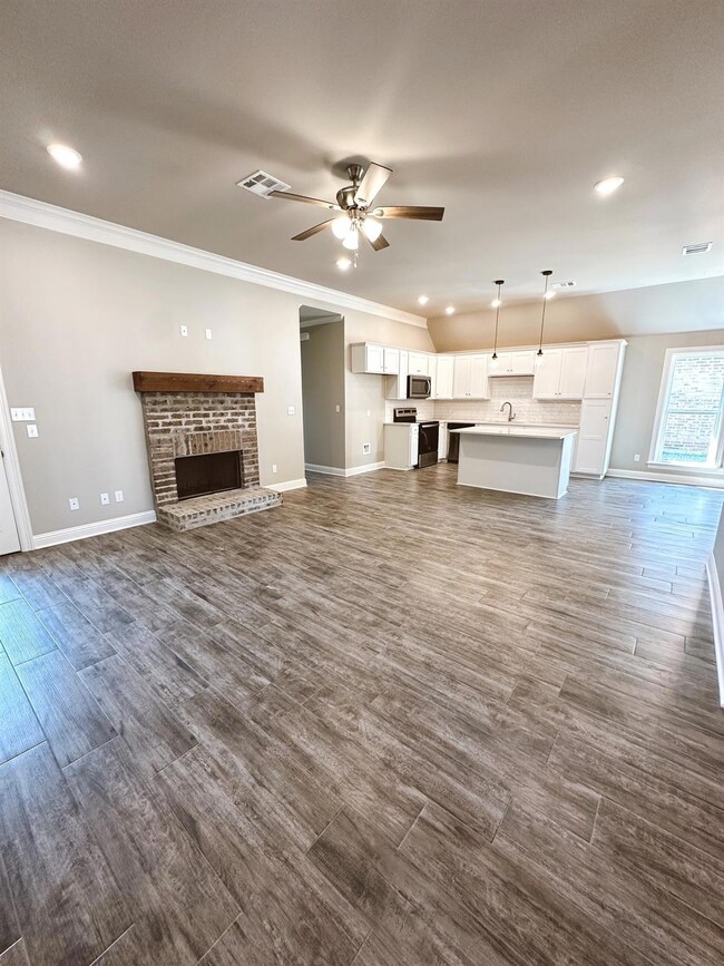 Unfurnished living room featuring crown molding, d