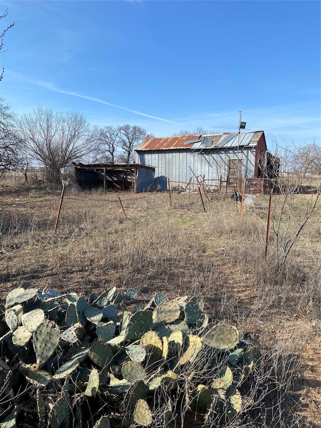View of yard featuring a rural view and an outbuil