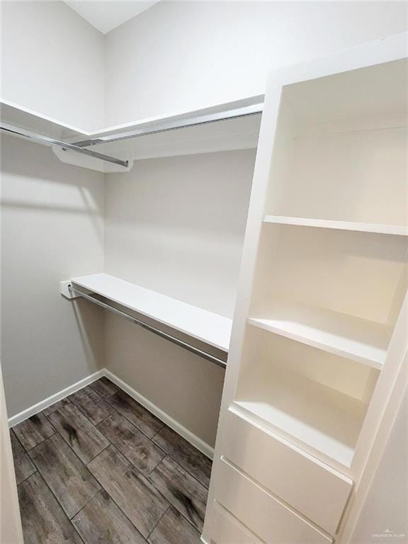 Walk in closet with wood finish floors