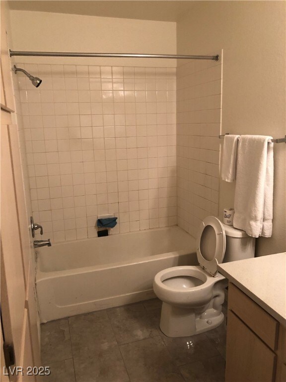 Bathroom featuring vanity, tile patterned floors, and shower / tub combination