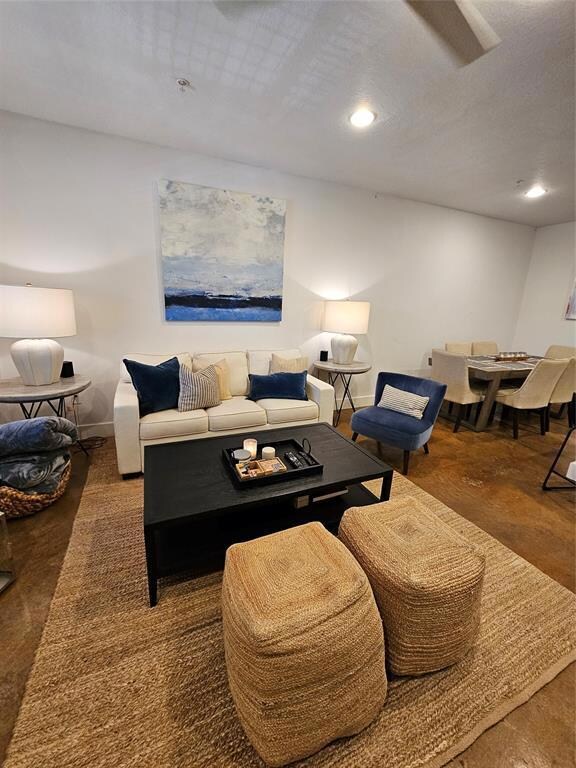 Living area featuring recessed lighting and baseb