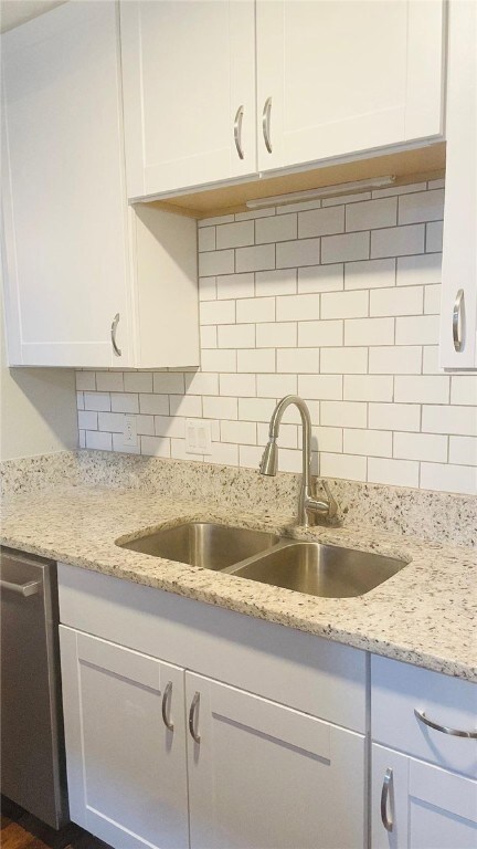 Kitchen featuring a sink, tasteful backsplash, whi