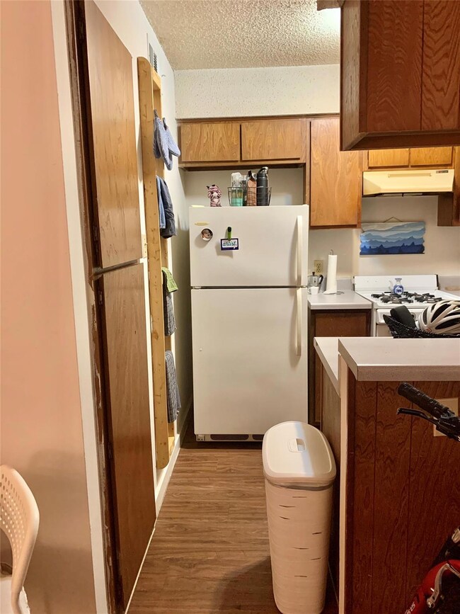 Kitchen featuring white appliances, under cabinet