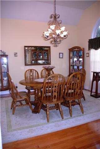 The dining room offers a vaulted ceiling and hardwood floors.